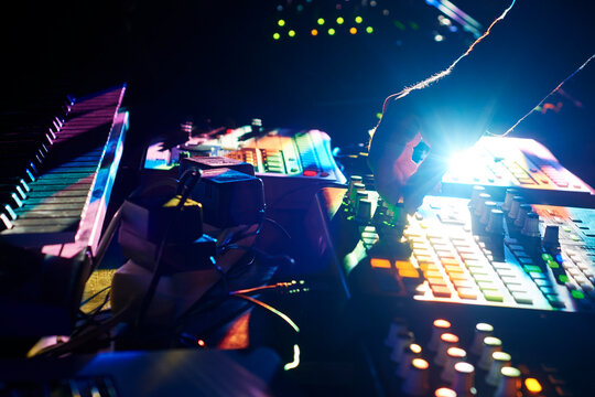 Electronic musician adjusting parameters on a controller