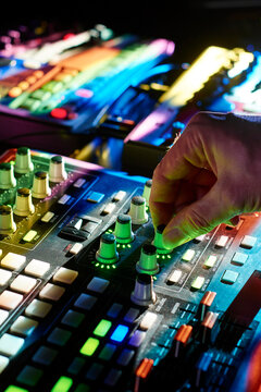 Electronic musician adjusting parameters on a controller