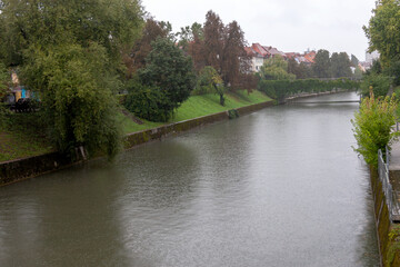 Fototapeta na wymiar The river in old town Ljubljana on a rainy day