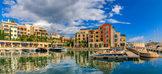 Fototapeta premium Scenic view of the Adriatic Sea marina with luxury residential buildings and boats in the background in Tivat Montenegro