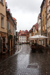 Fototapeta na wymiar The old narrow street on a rainy day