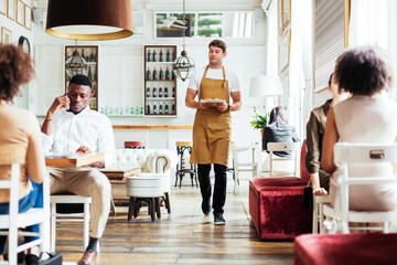 Waiter carrying dish in cafe