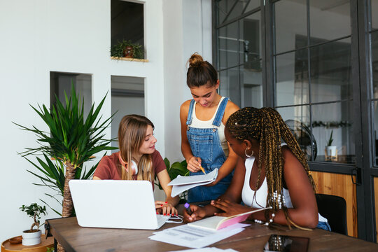 Teenager asking advice from diverse classmates