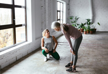 Tired mature woman communicating with coach