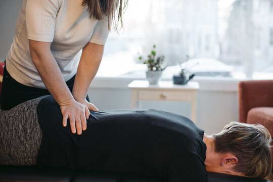 Young woman chiropractor giving treatment.