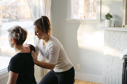 Young woman chiropractor giving treatment.