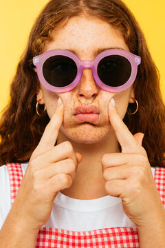 Funny ginger girl with pouting cheeks