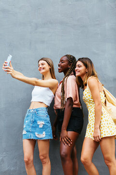 Cheerful Diverse Teenagers Taking Selfie Near Wall