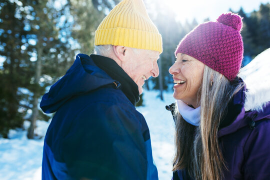 Happy mature couple in snowy forest