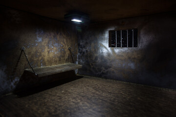 Jail or prison cell. Old grunge prison miniature. Dark prison interior creative decoration. Empty...