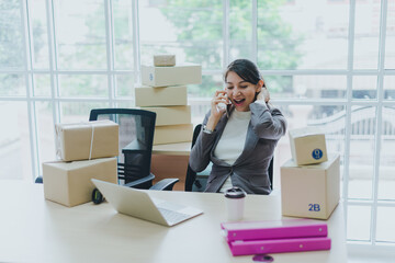 A beautiful businesswoman working at home is checking orders for products to be delivered to her...