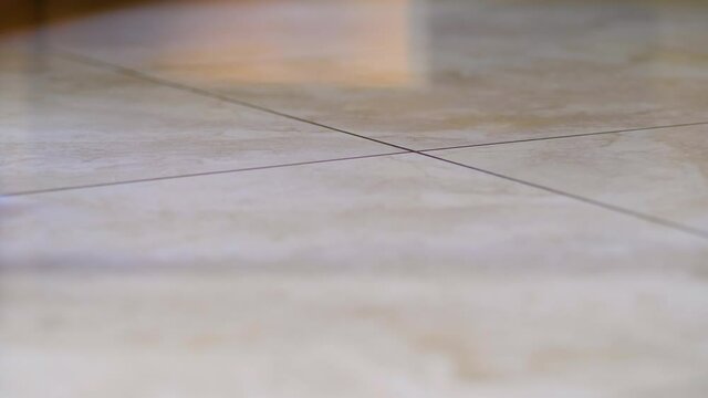 Close-up of the mop with the microfibre cloth when cleaning a polished polished marble effect floor.
