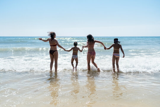 Mother and daughters on the beach