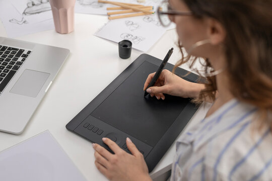 Detail shot of woman working on a graphic tablet
