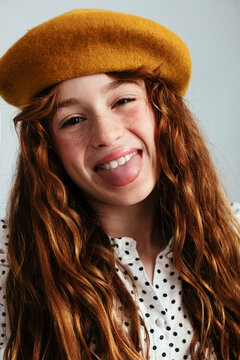 Cheerful girl sticking the tongue at camera