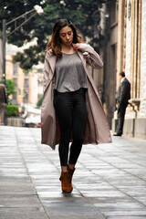 Fototapeta premium Attractive lady walking in the street in a rainy day