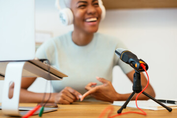 Microphone and laptop near blurred black speaker