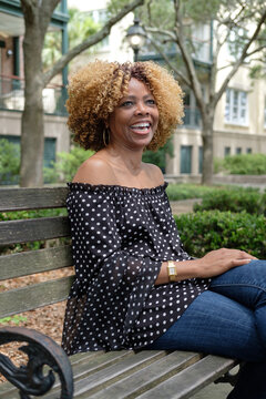 Middle-aged black woman in urban park.