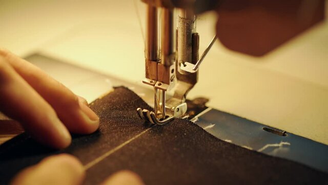 tailor sewing on sewing machine.