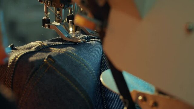 Close-up shot of sewing jeans on the sewing machine.