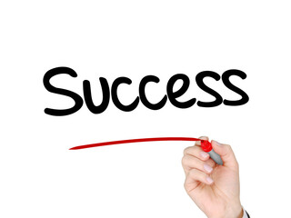 A hand with a marker writing 'Success' for achievement in life or business theme.