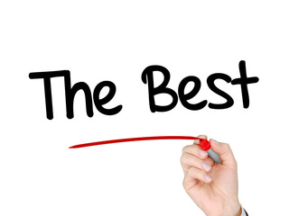 A hand with a marker writing 'The Best' for human achievement concept / theme.