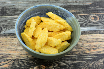 Cheese oregano and basil bread rusks in ceramic snack bowl on table