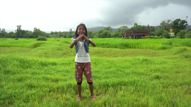 little girl dancing  near temple  farm malvan maharashtra
