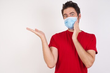 Young caucasian man with short hair wearing medical mask standing over isolated white background hold open palm new product great proposition