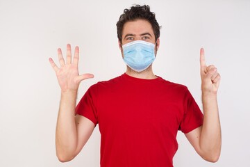 Young handsome caucasian man wearing t-shirt over isolated white background showing and pointing up with fingers number six while smiling confident and happy.
