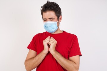 Young caucasian man with short hair wearing medical mask standing  desperate and depressed with tears on her eyes suffering pain and depression  in sadness facial expression and emotion concept