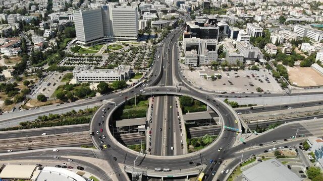 Aerial fly over scene of the ring road intersection between Kifissias Avenue and Attiki Odos motorway. A major transport hub in northern Athens, connecting city with the airport. Marousi, Greece.