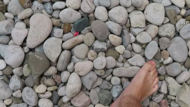Walking barefoot on river rocks / stones 