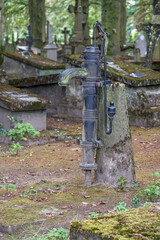 Fototapeta na wymiar Hand pump in a graveyard