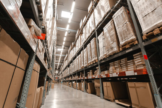 Warehouse interior with shelves, pallets and boxes, Rows of shelves with goods boxes in modern industry warehouse store at factory warehouse storage.