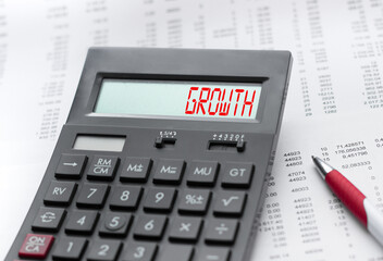 A calculator with the inscription GROWTH . Business profit concept