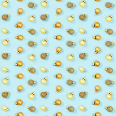 Seamless regular creative pattern with bright shiny little Christmas balls on blue paper.