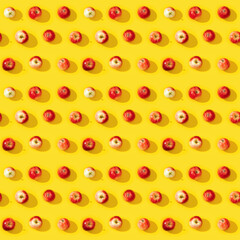 Seamless regular creative pattern from small red apples, good autumn harvest.