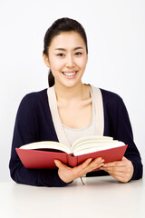 smiling woman holding a book