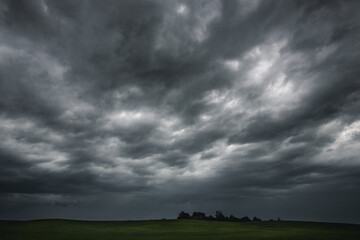 Fototapeta na wymiar Cloudy stormy sky above green fields