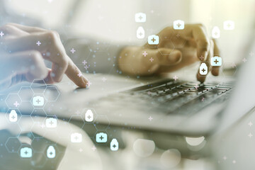 Creative concept of abstract medical illustration and hands typing on laptop on background....