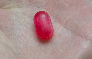 red candy in the palm