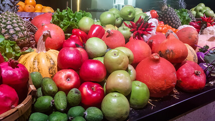 Various vegetables and fruits are on the counter in the store