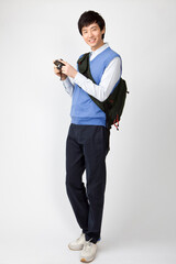 young man in casual dress standing with bag