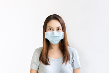 Beautiful young Asian woman with protective face mask on white background. New normal, health care concept