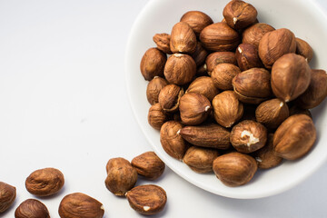 Close-up of nuts in a white Cup isolated on a white background.