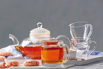 Composition with hot tea and sweets on table