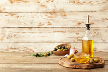 Composition with olive oil on wooden table