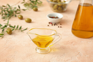 Gravy-boat of olive oil on table