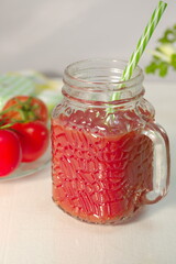 Freshly prepared tomato juice with celery leaves in a glass Cup is on the table. The concept of healthy food. It is an element of vegetarianism, keto diet, paleo diet